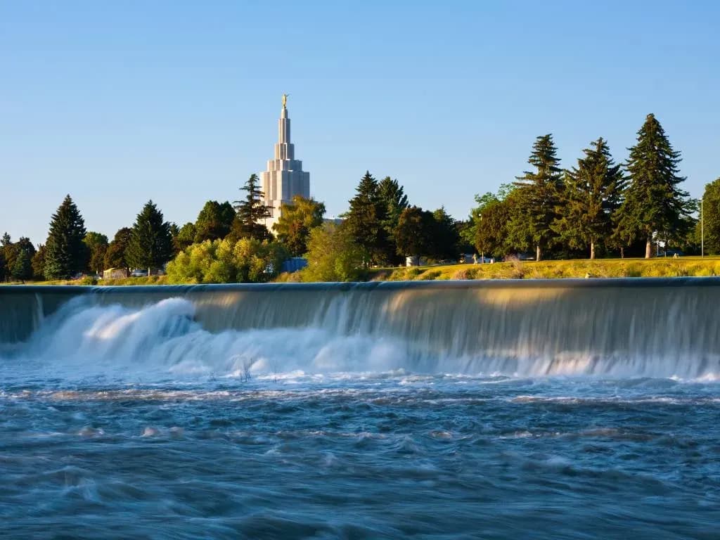 idaho falls with water trees and mormon temple in the background