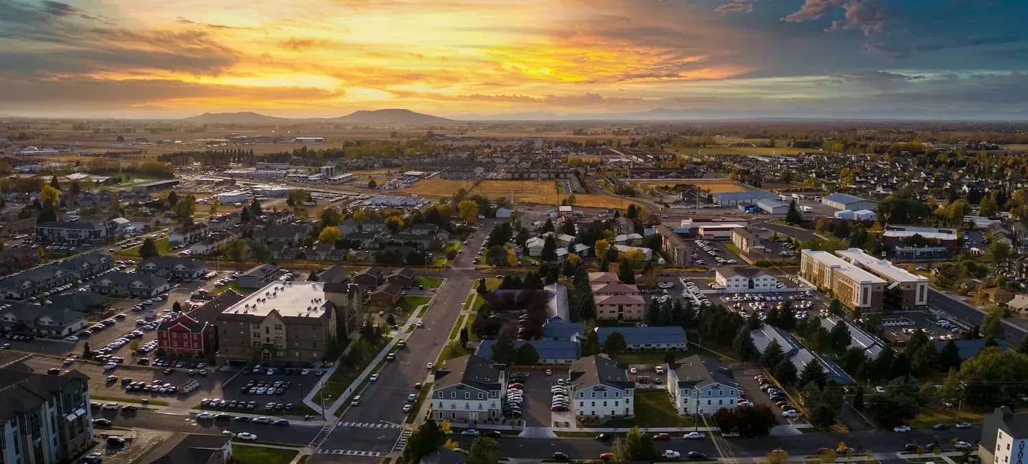 rexburg idaho aerial shot at sunset highlighting downtown and apartments