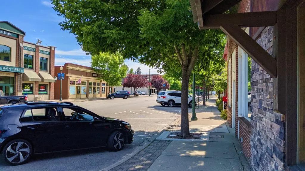 rathdrum idaho downtown on a sunny day with trees and cars
